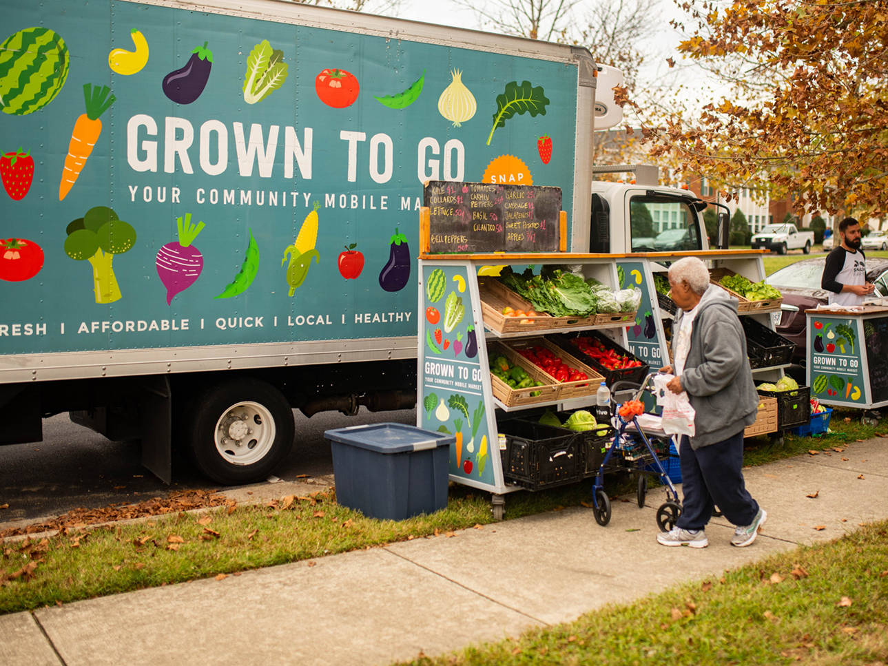 Shalom Farms | Customer in front of produce stand at Grown to Go Mobile Market