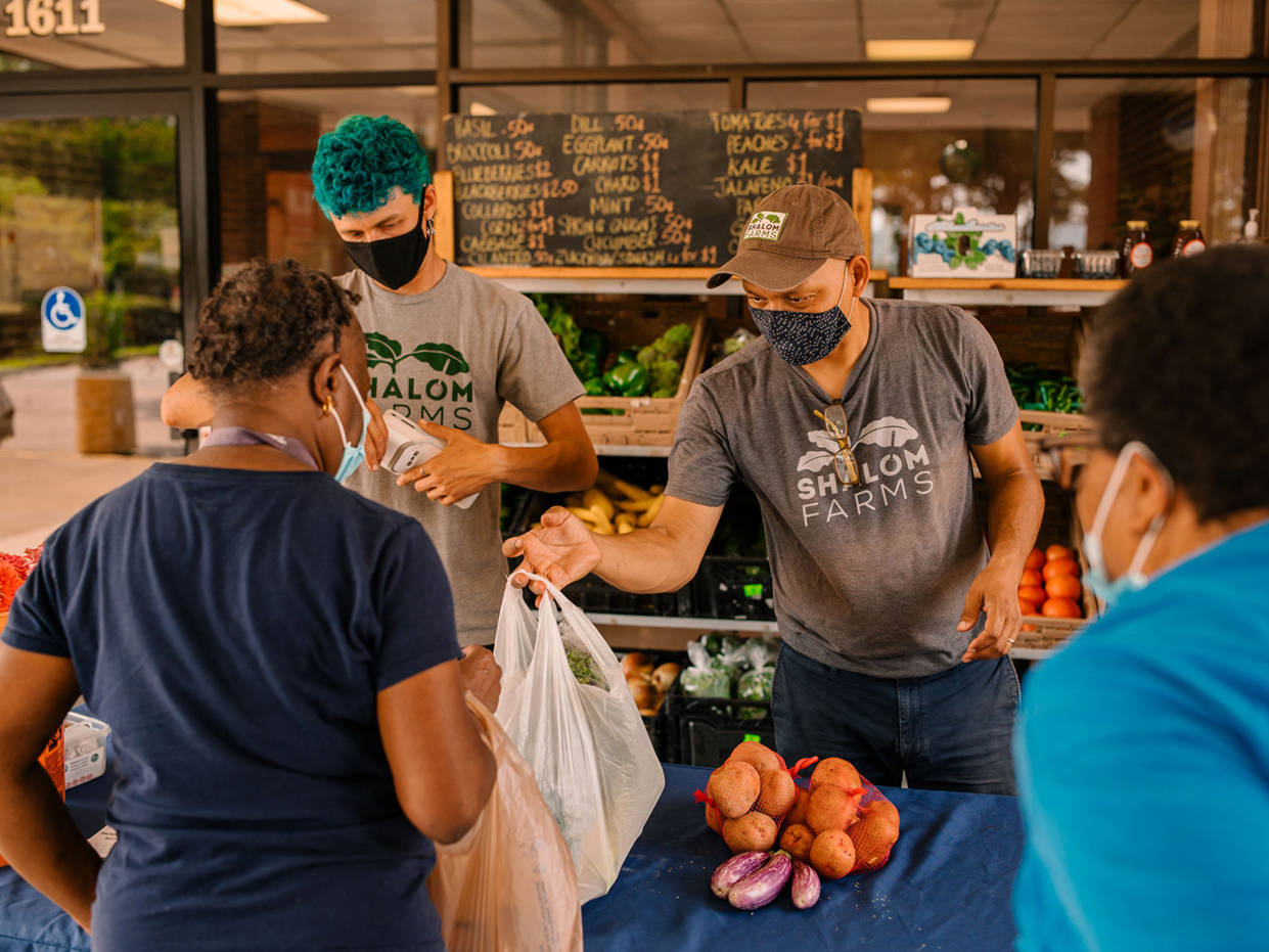 Shalom Farms employees serving customers at Mobile Market