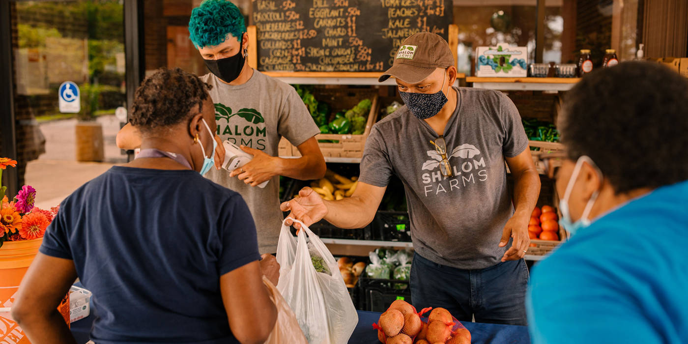 Shalom Farms employees serving customers at Mobile Market