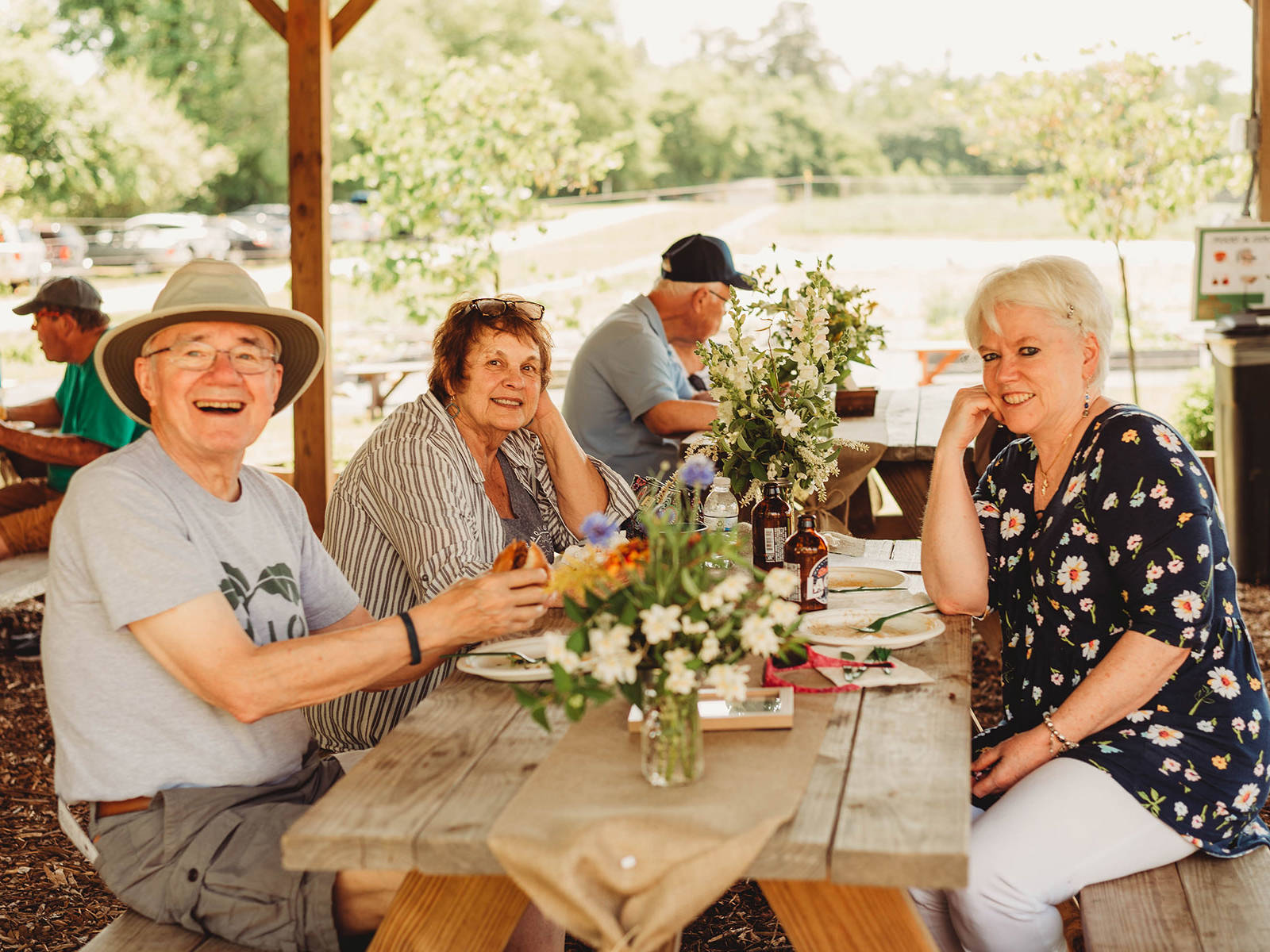 Shalom Farms | Group gathered around picnic table at farm event