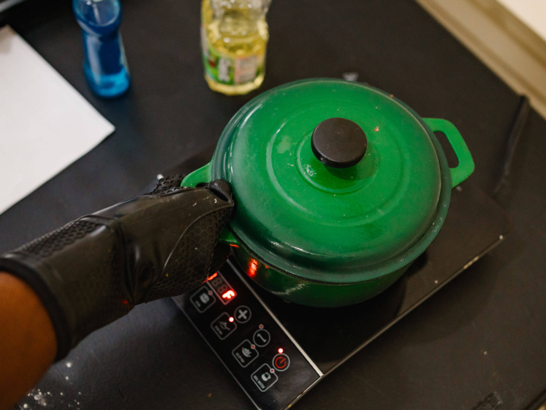 Man reaching for pot on hot plate